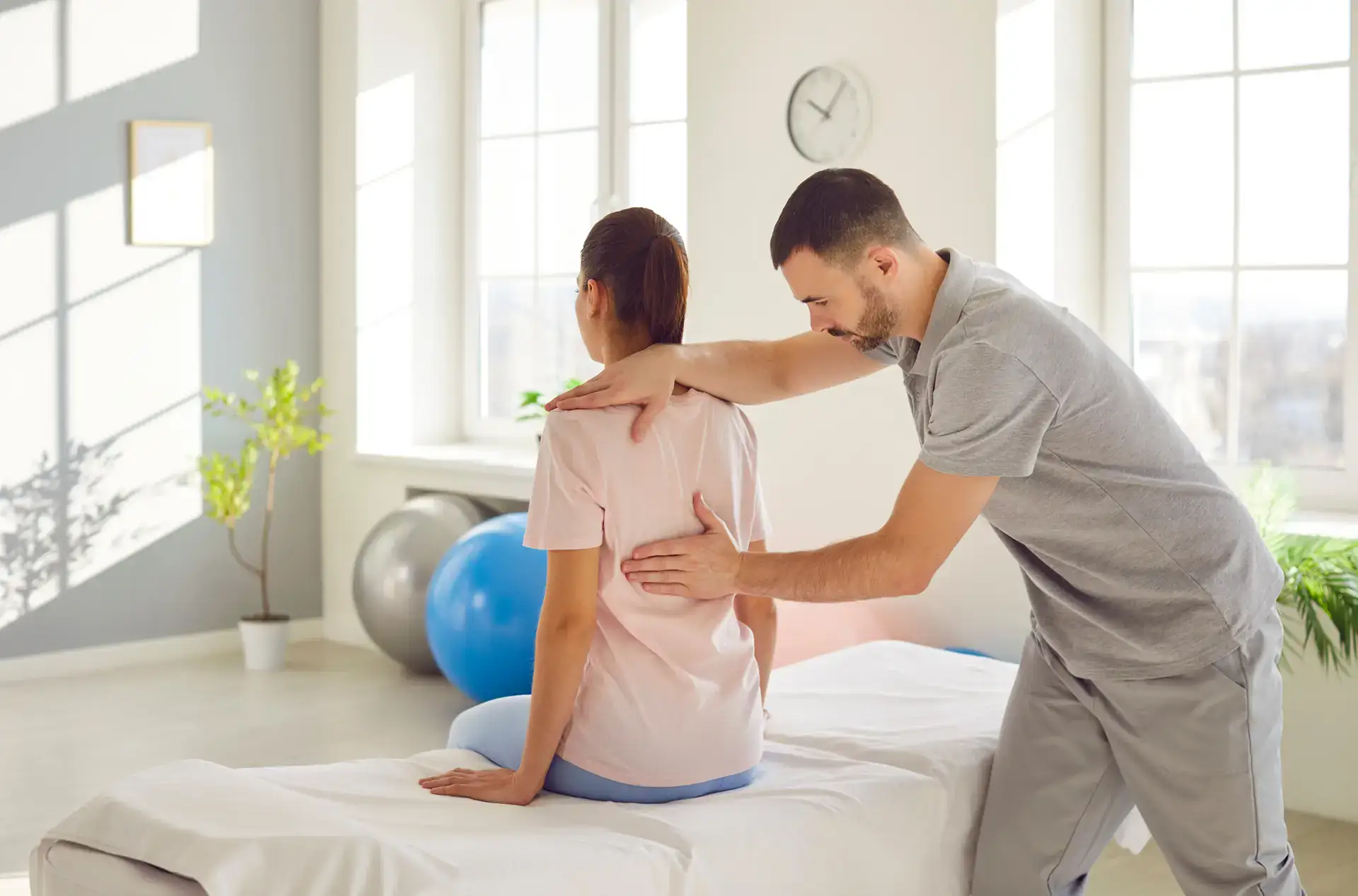 A chiropractor performs a spinal adjustment on a patient in a modern treatment room. This image highlights the chiropractic services available for patients seeking pain relief in Grand Rapids, MI.