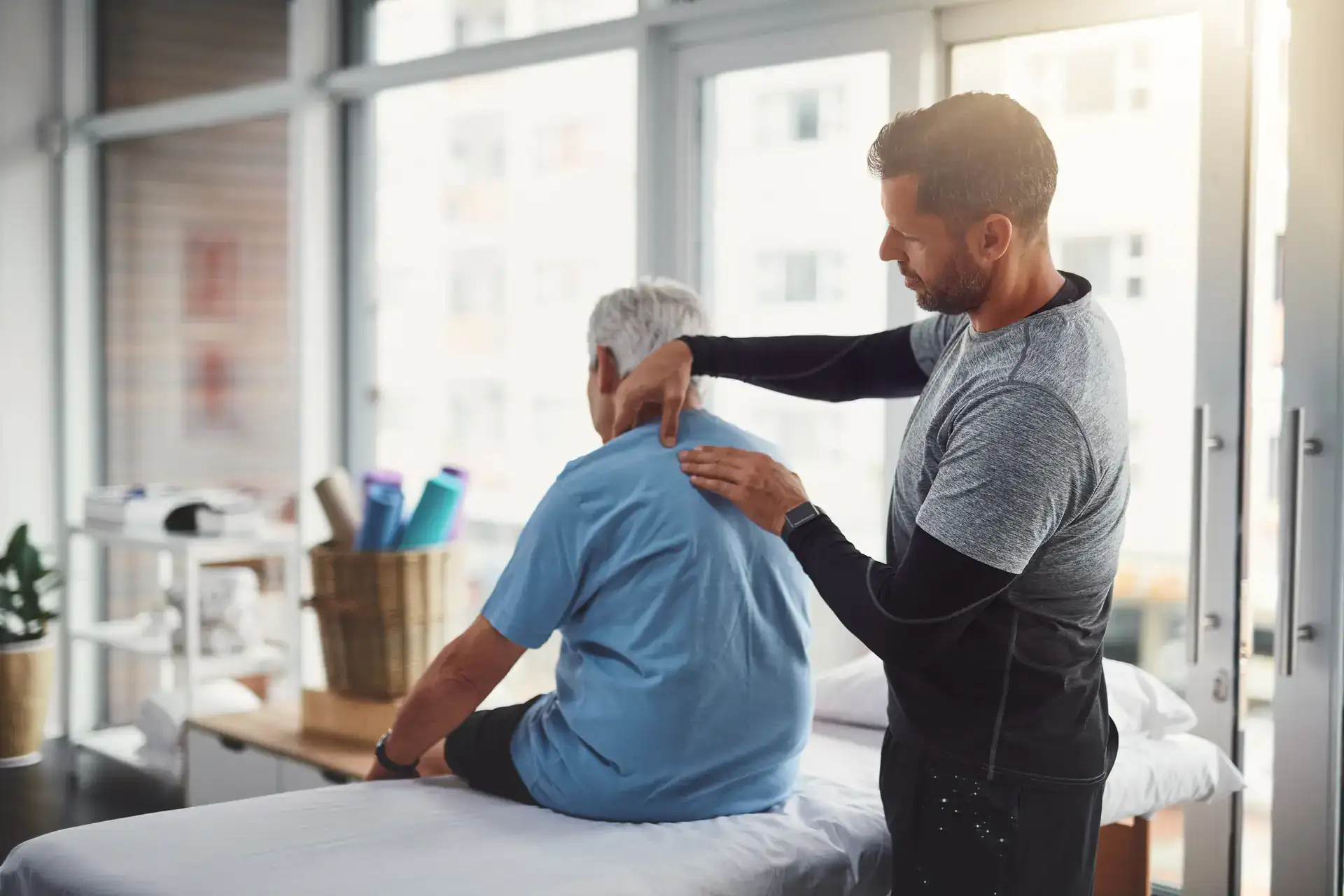 A client is shown receiving a relaxing massage from a professional therapist in a calm, softly lit treatment room. The image signifies the peaceful and healing environment of a massage therapy session in Grand Rapids, MI.