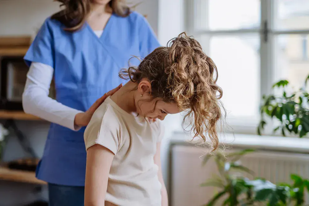 Chiropractic First nurse performing a child posture checkup in Kent County, Michigan, ensuring healthy spinal alignment and growth